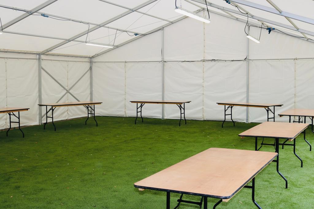 A tent with tables and benches inside of it