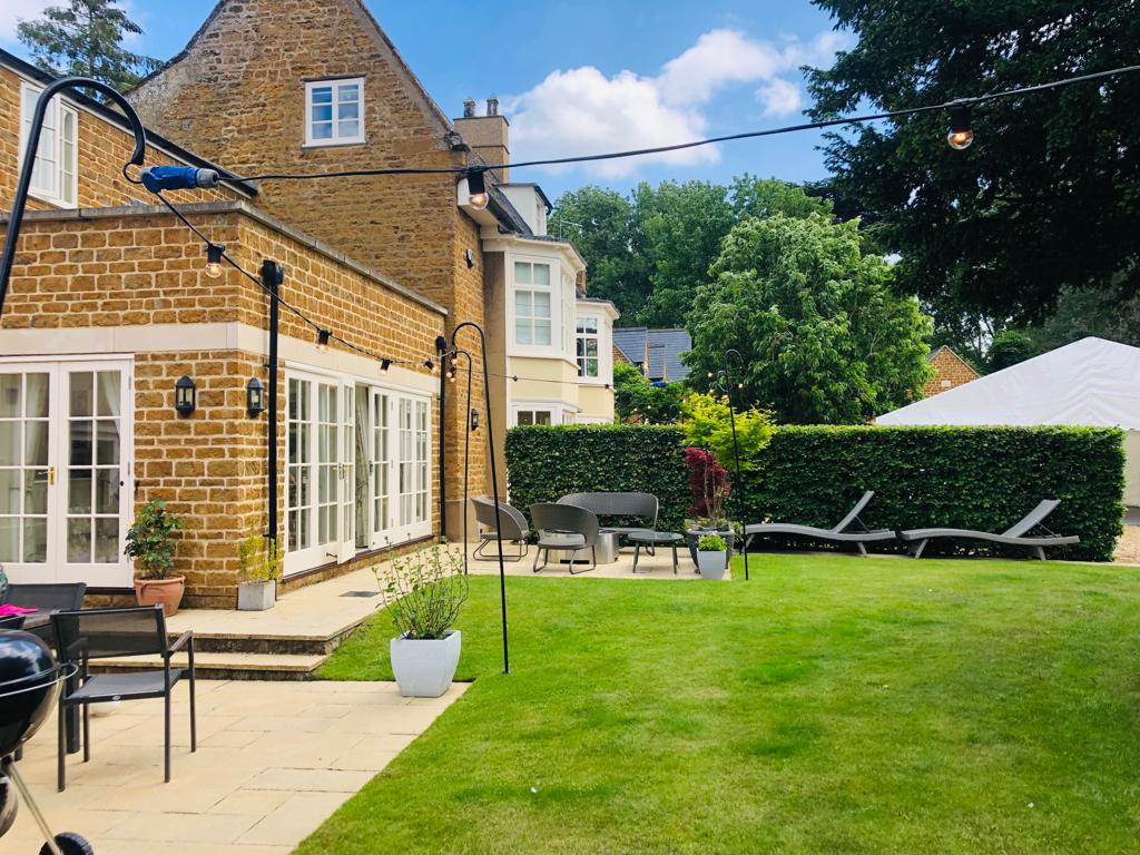 A large brick house with a large lawn in front of it