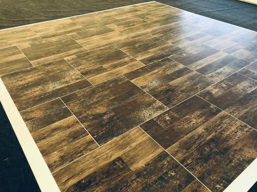 A large wooden dance floor with a white border.