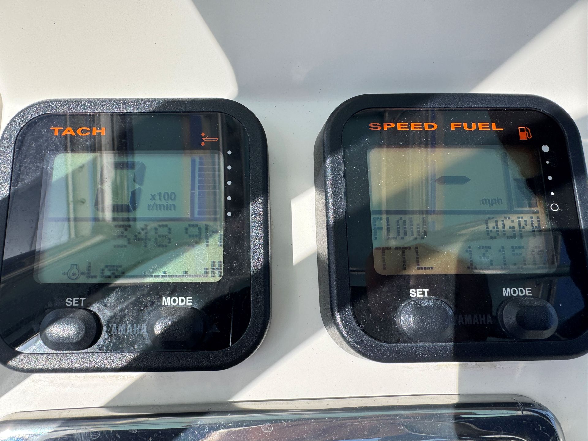 Two digital dashboard displays labeled tach and speed/fuel, showing a vehicle instrument panel.