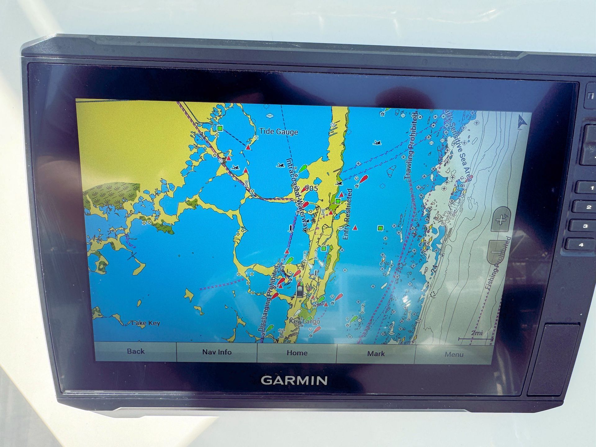 Garmin GPS screen showing a colorful map with blue water and yellow land.