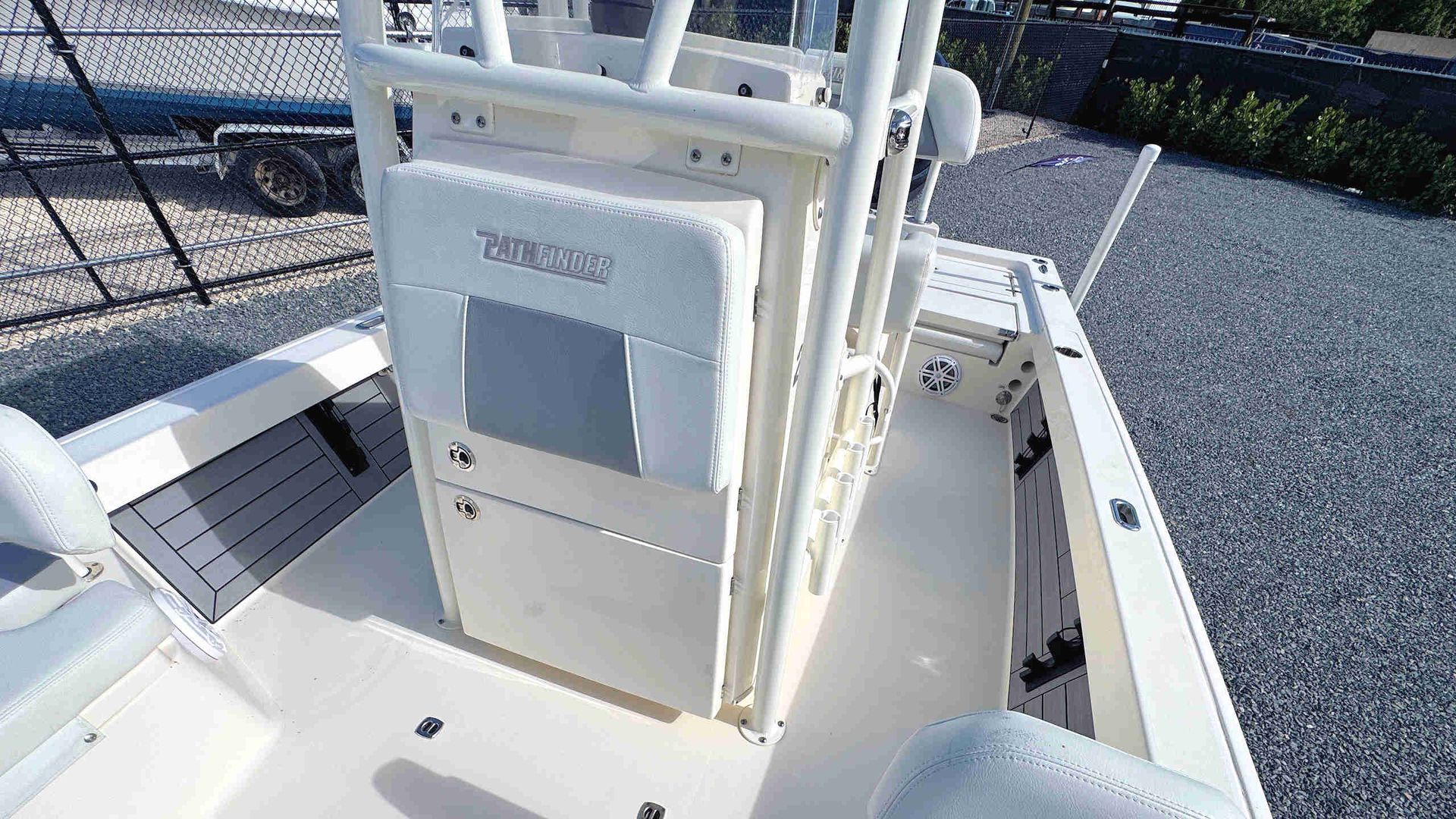 White boat console with storage cabinet and rod holders on a sunny deck, viewed from above