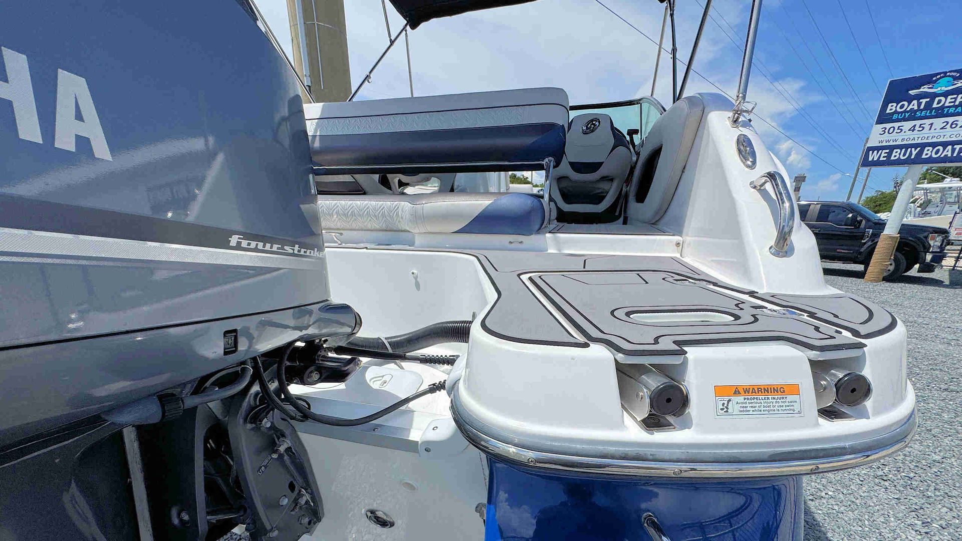 Close-up of a white Yamaha boat stern and outboard motor at a marina display.