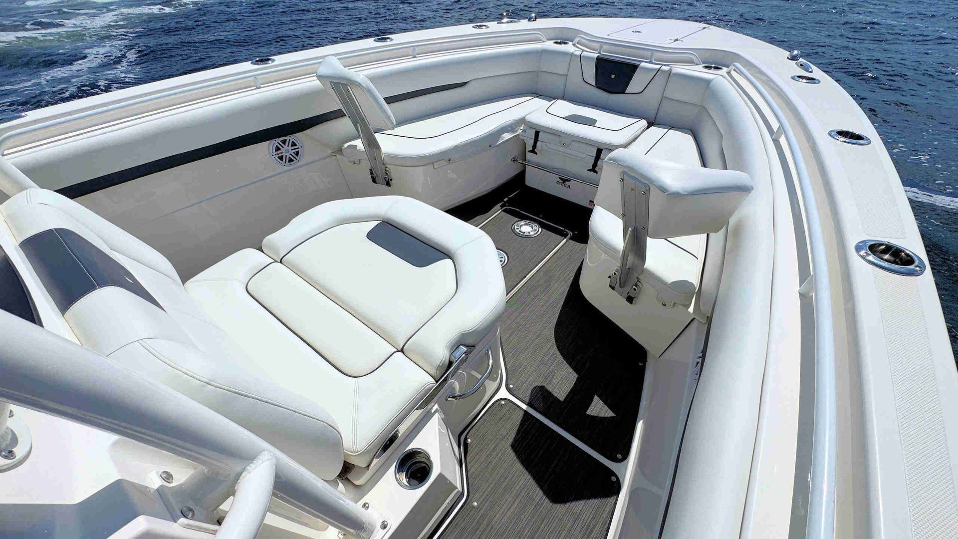 White cushioned foredeck seating in a bright open cockpit on a sunny day