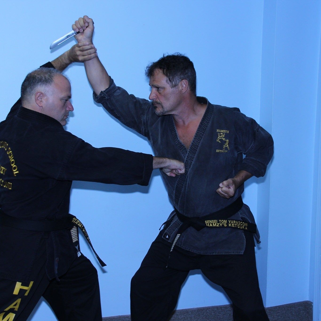 Two men in karate uniforms with the word ham on the back
