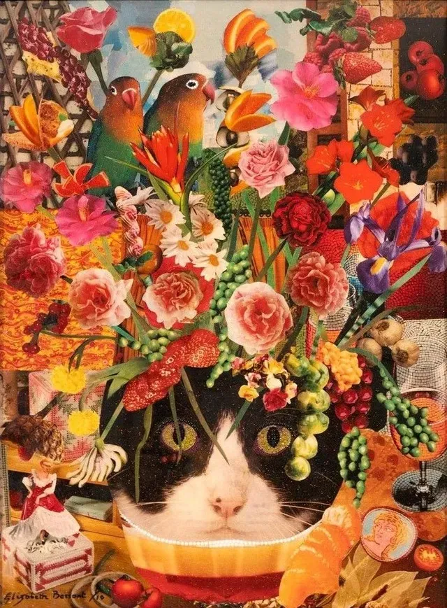 Cat in a basket topped with a colorful bouquet and flowers, surrounded by fruit and decorative items
