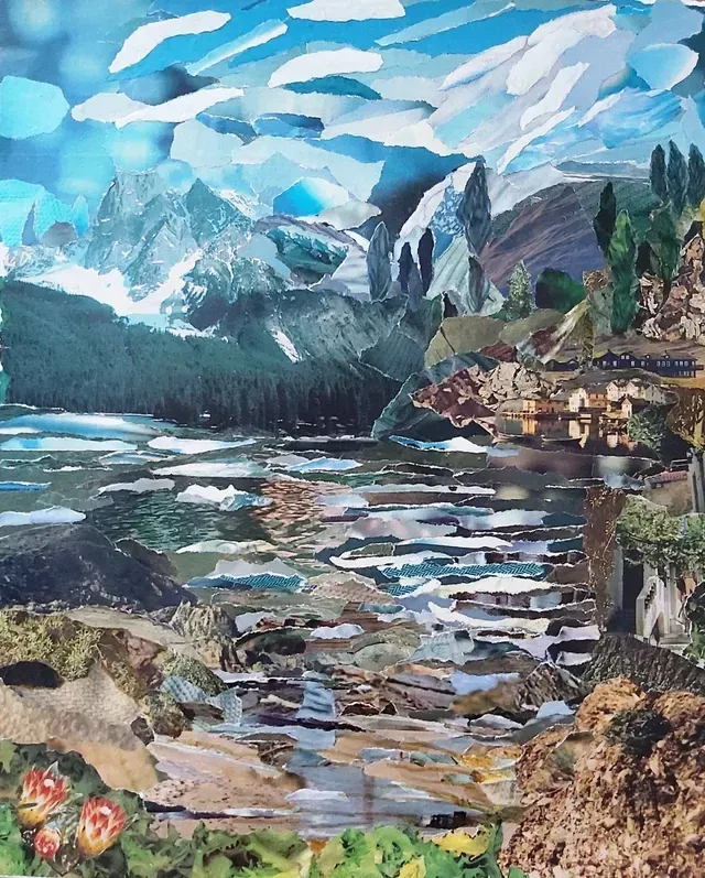 Mountain lake landscape with snowy peaks, blue sky, forested shore, and a village by the water