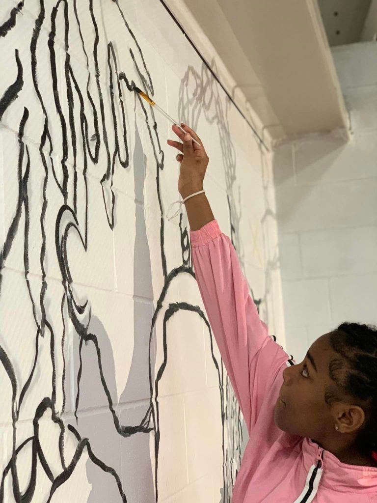 girl painting mural