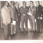 historic photo of men standing in line