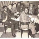 historic photo of men around table