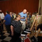 people observing paintings