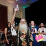 man with beard holding up drink