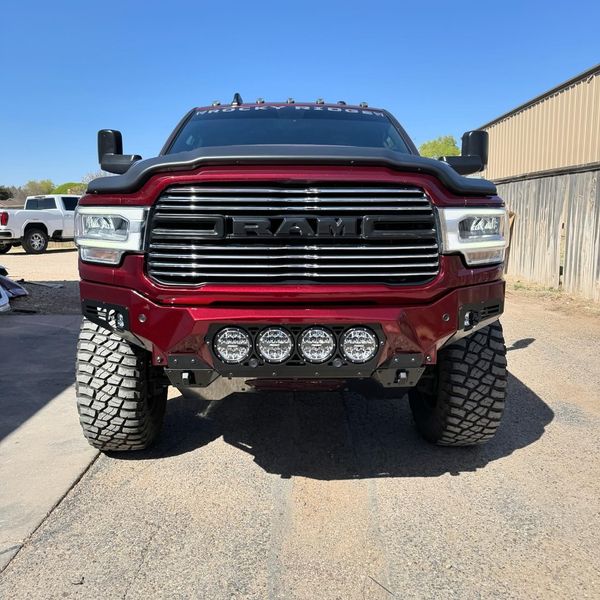 A red ram truck is parked in a parking lot