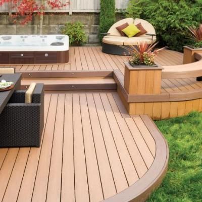 A wooden deck with a hot tub in the background