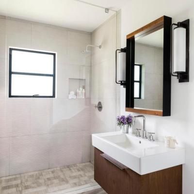 A bathroom with a sink a mirror and a window