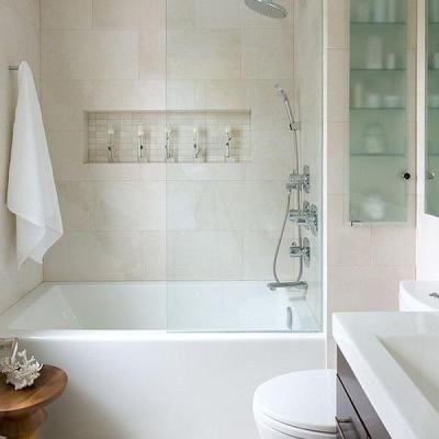 A bathroom with a tub , toilet , sink and shower