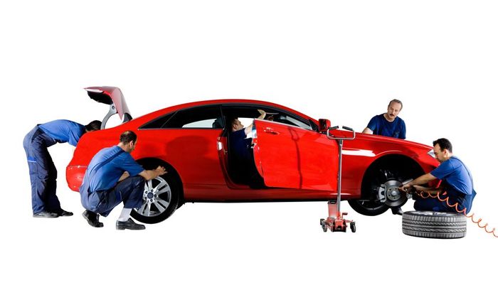 A Group Of Mechanics Are Working On A Red Car - Dover, NJ - Roger Coss Auto Body A Group Of Mechanics Are Working On A Red Car - Dover, NJ - Roger Coss Auto Body