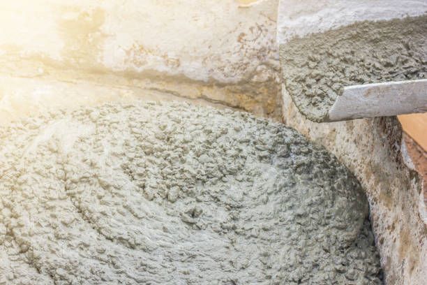 Concrete pouring, showcasing ready mix cement texture for smooth mortar finish.