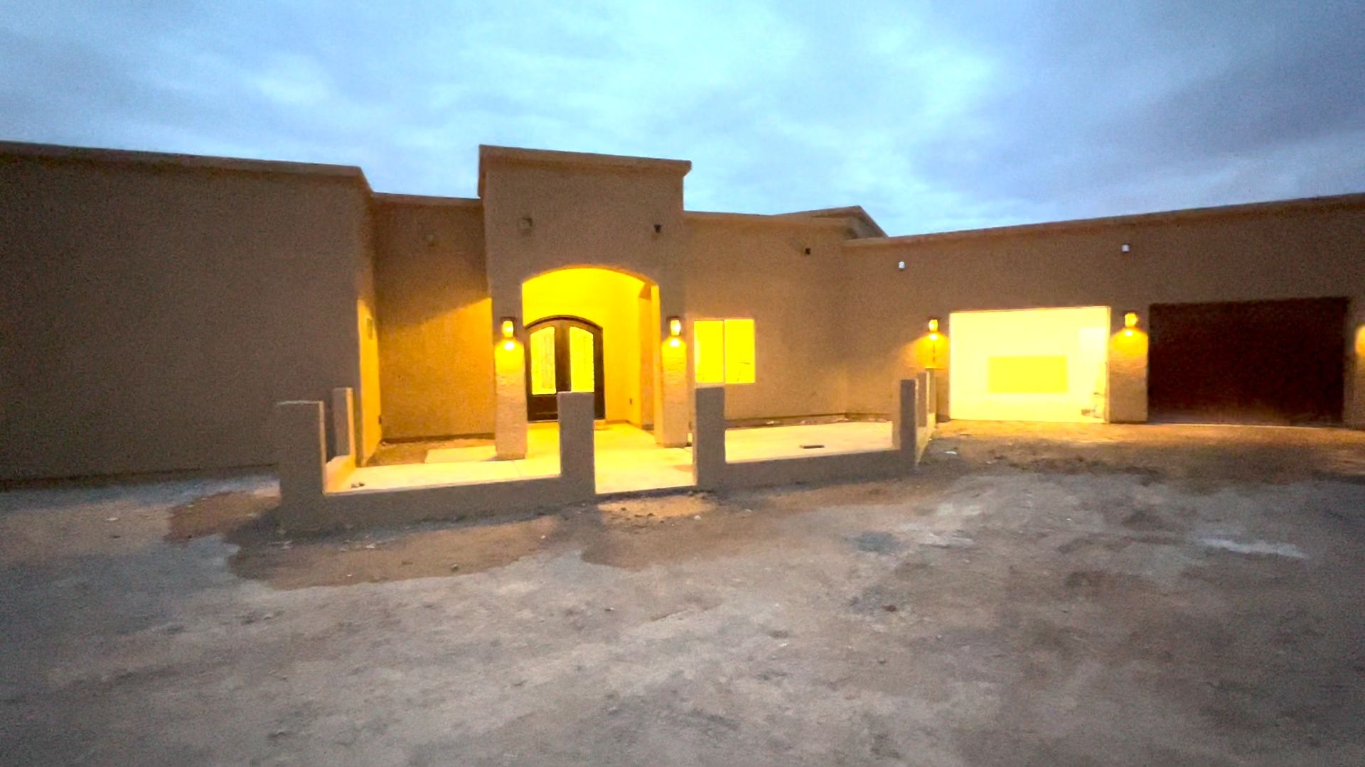The front of a house is lit up at night