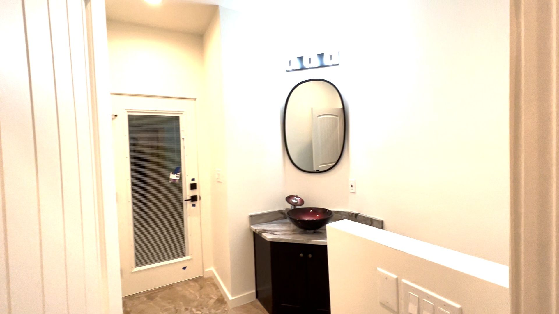 A bathroom with a sink and a mirror on the wall.