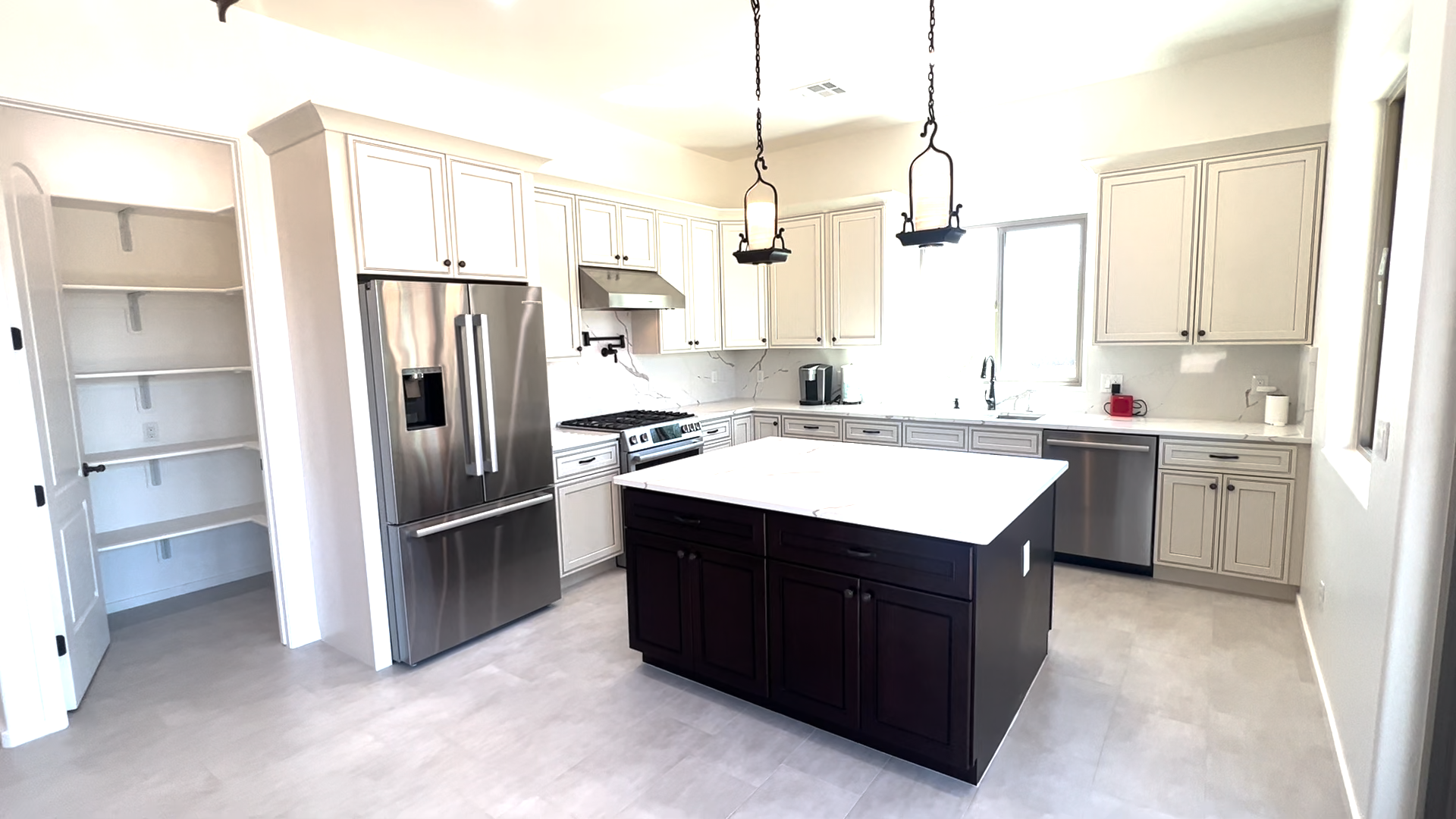 A recently remodeled kitchen with a large stainless steel refridgerator and an island