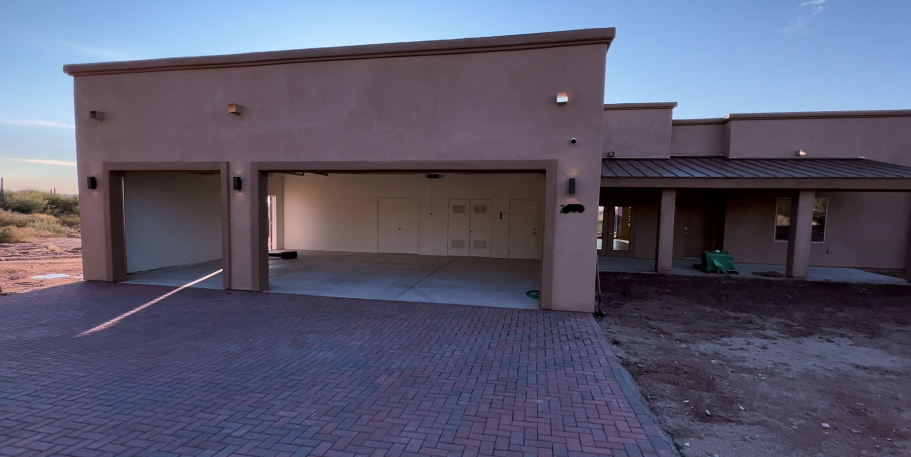 A house with a large garage and a brick driveway