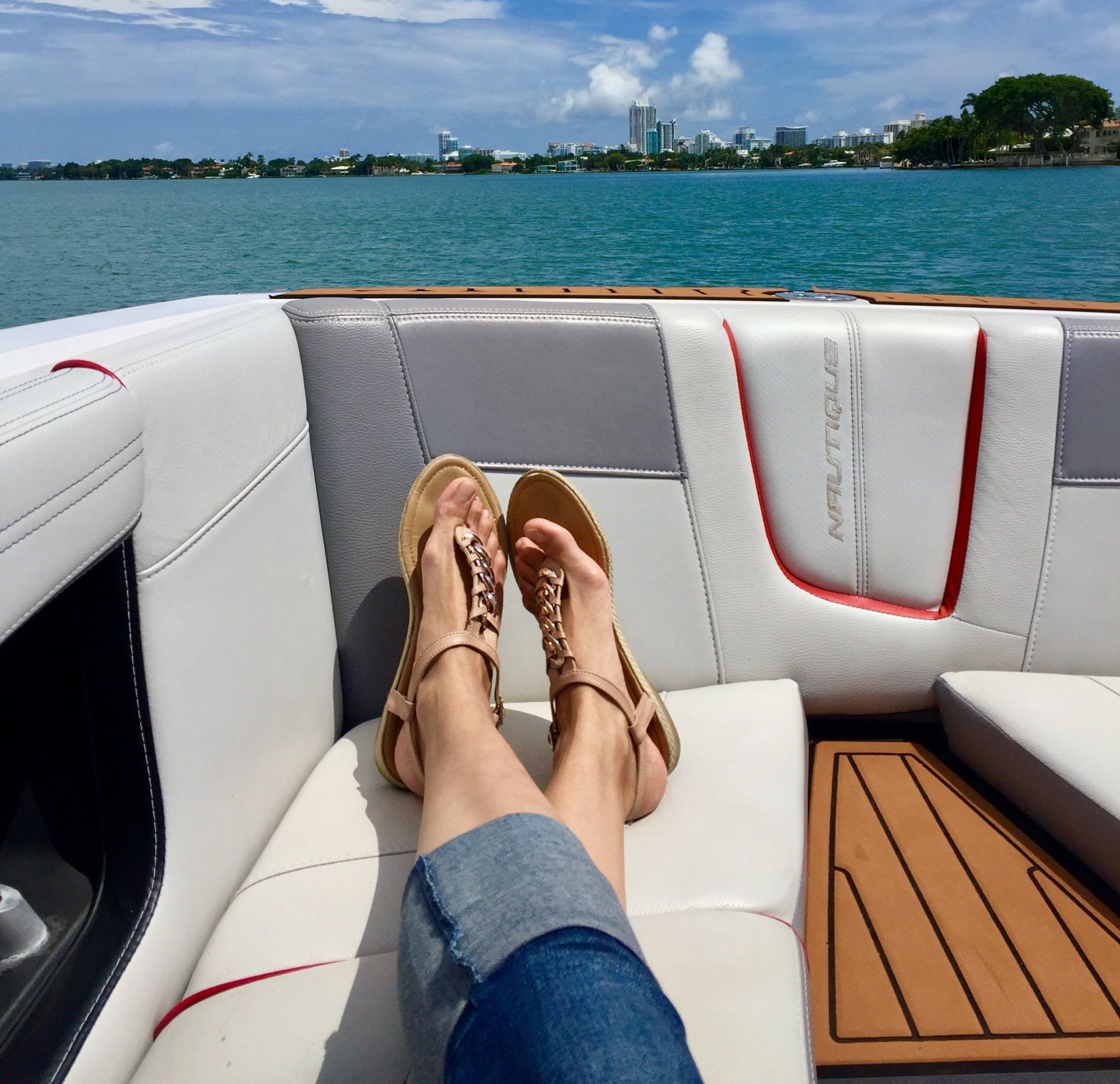 A person laying on a boat with their feet up
