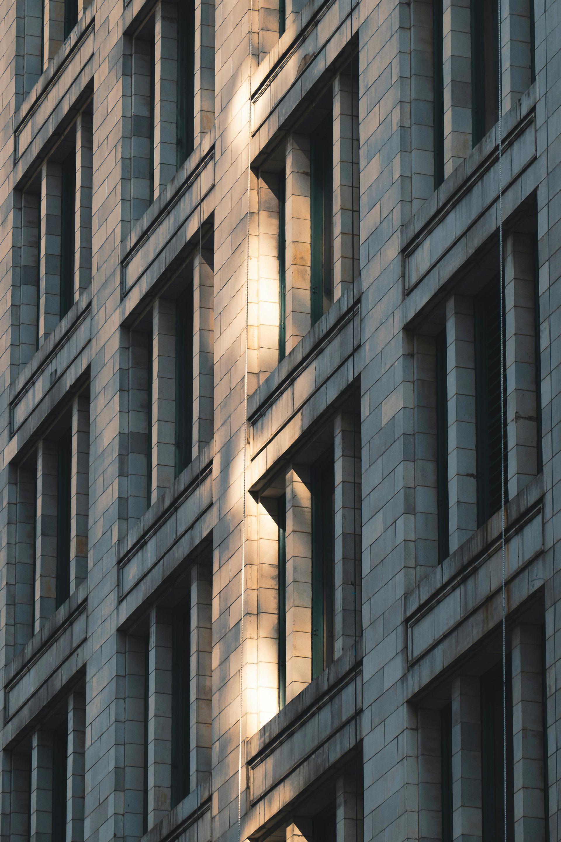 The sun is shining through the windows of a tall building.