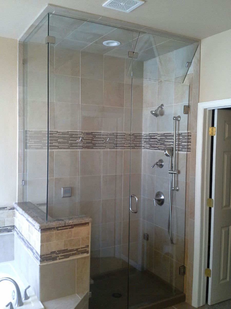 Modern bathroom with a glass-enclosed shower and beige tile accents