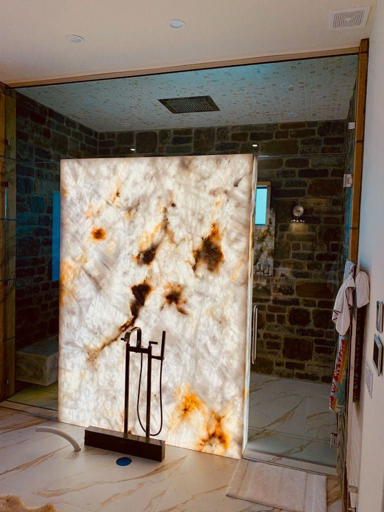 Marbled white partition panel with rust stains in a tiled indoor room with a doorway and hanging clothes