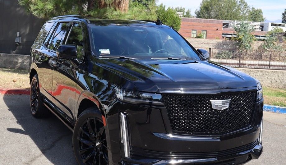 Black Cadillac Escalade SUV parked outdoors with blacked-out trim.