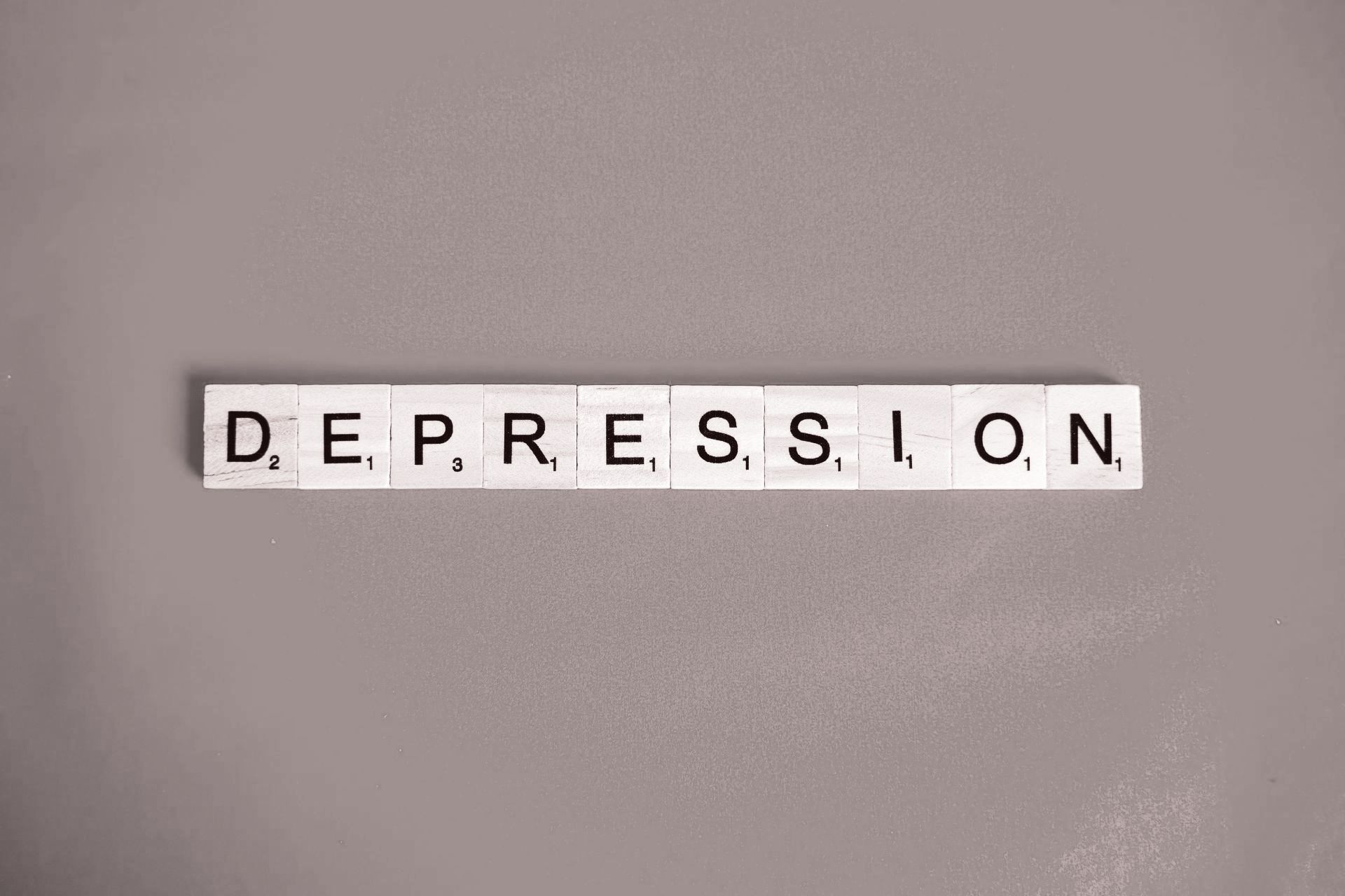 the word depression with scrabble game letters. 