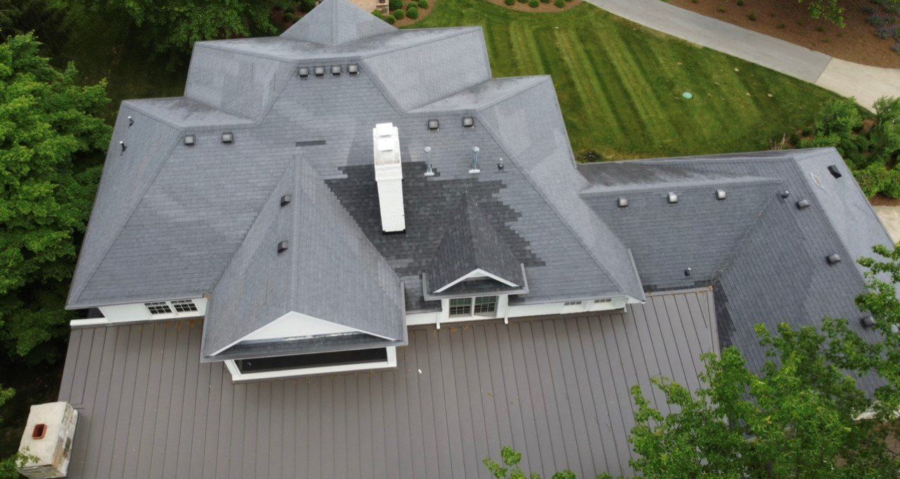 Far aerial view of large mansion with gray roof with crops in background — Georgetown, IN — ARC Roofing LLC