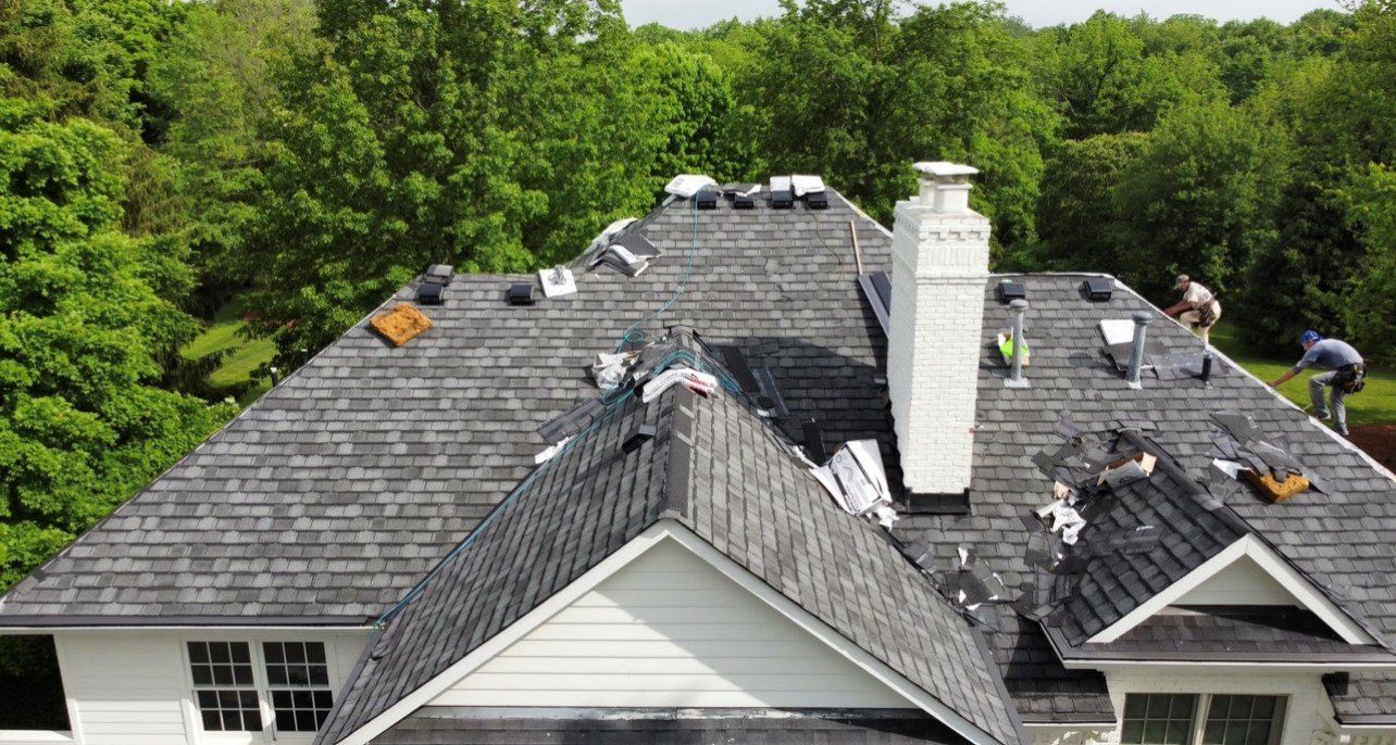Nice angle of gray roof of white house with white chimney — Georgetown, IN — ARC Roofing LLC