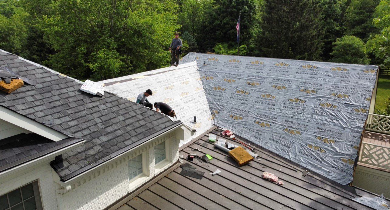 Man watching over two workers working on roof — Georgetown, IN — ARC Roofing LLC