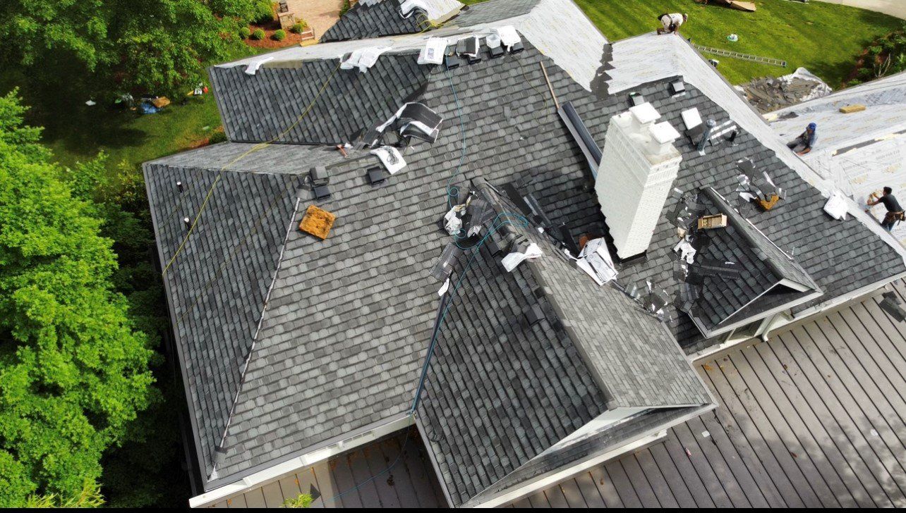 Top down view of workers working on gray roof — Georgetown, IN — ARC Roofing LLC