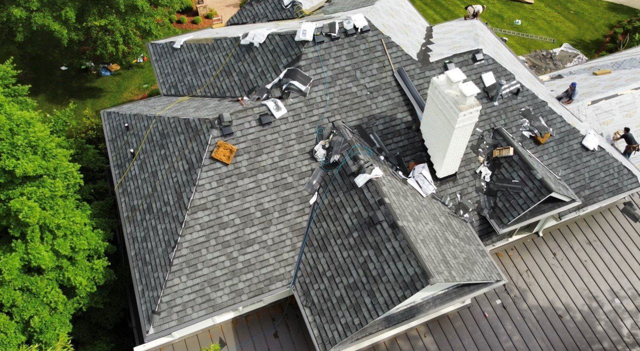 Top down view of workers working on gray roof — Georgetown, IN — ARC Roofing LLC