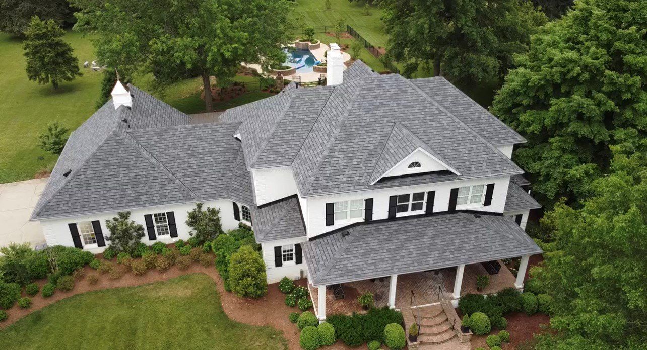 Large and wide white house with gray roof with pool in background — Georgetown, IN — ARC Roofing LLC