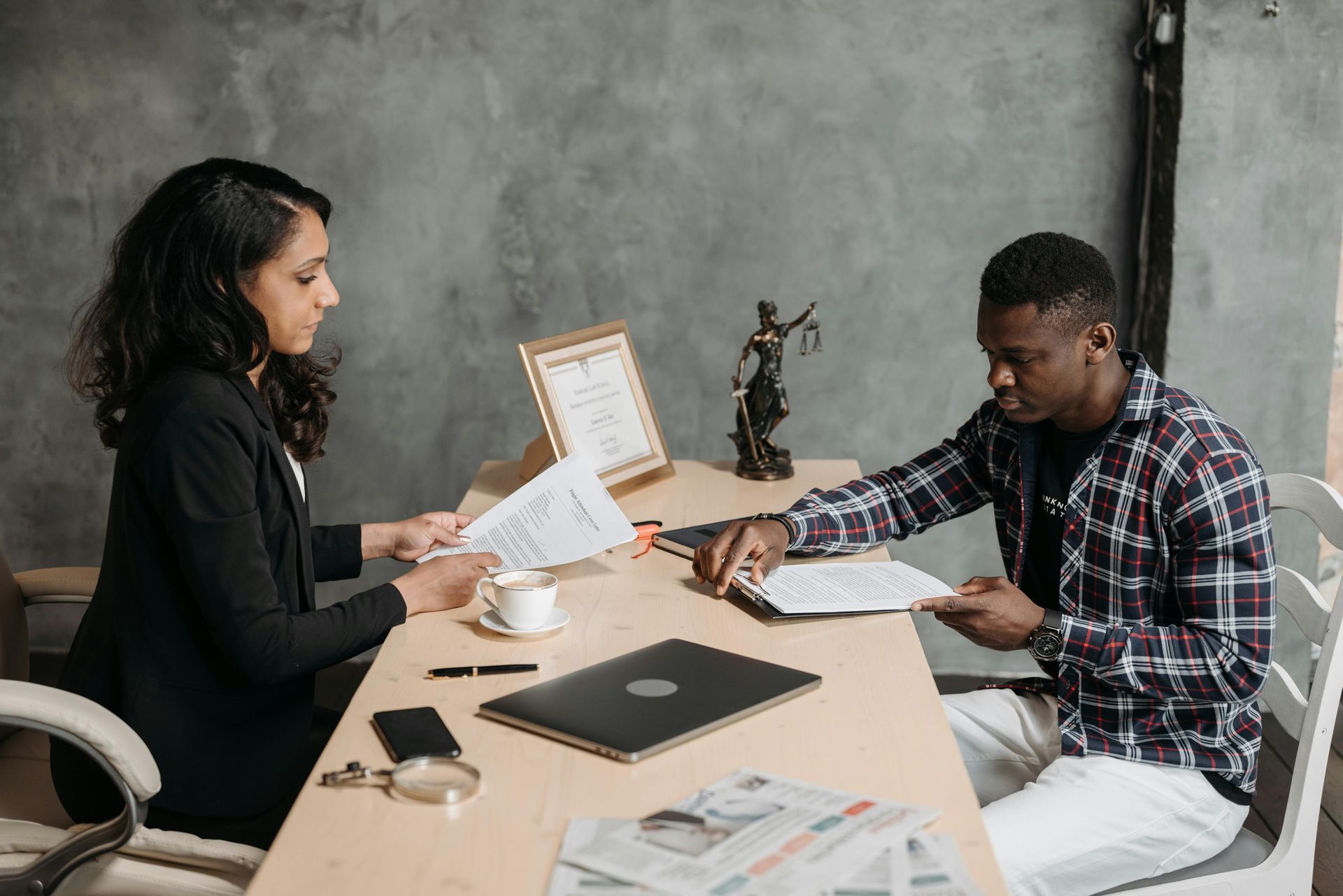 A lawyer and client discussing legal options related to workplace mental health accommodations in an office setting