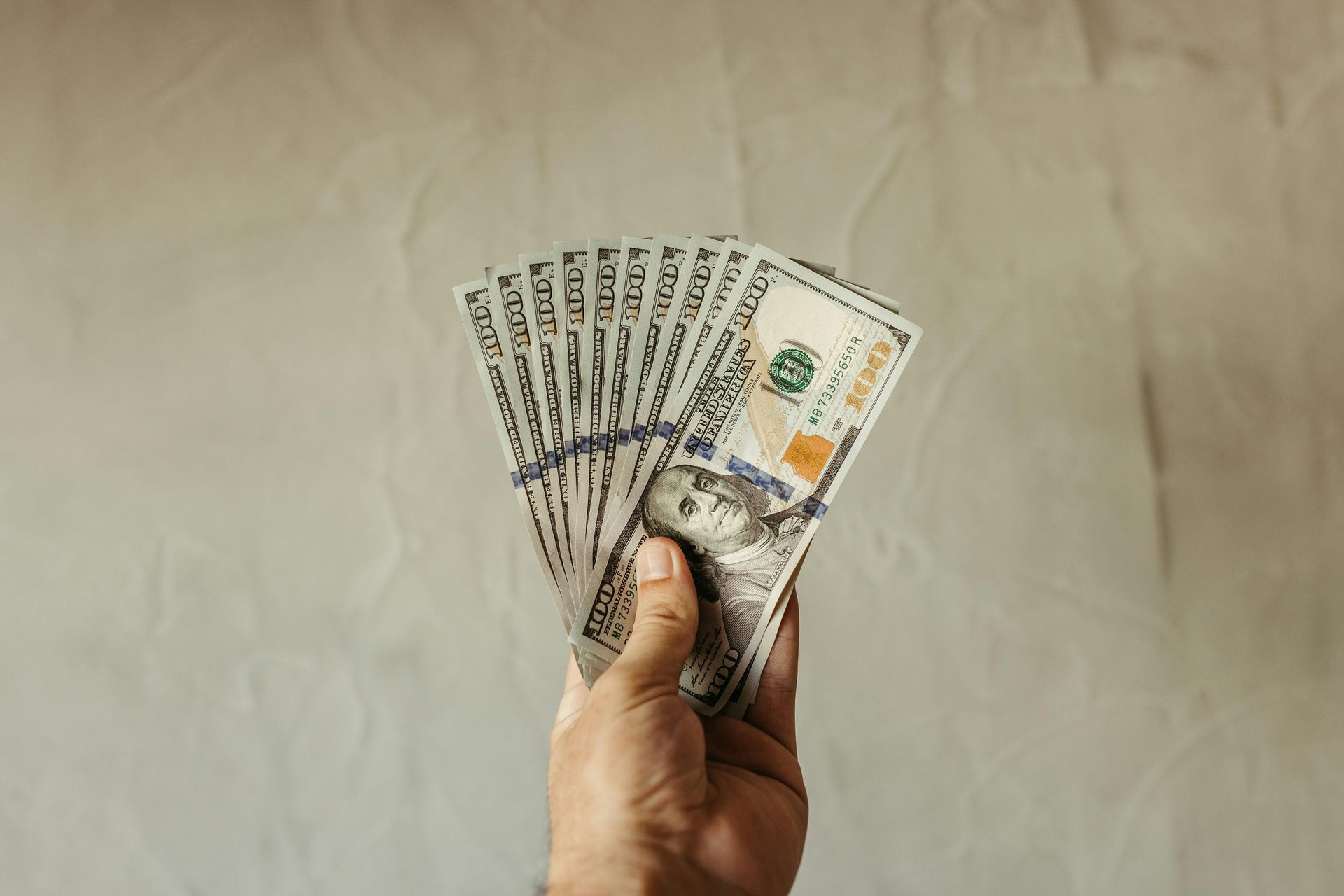 Hand holding money representing transparency In pay laws