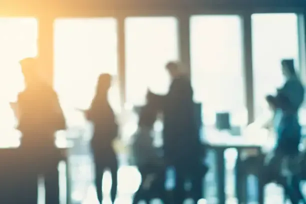 Silhouetted employees in an office during job year-end terminations in Colorado.