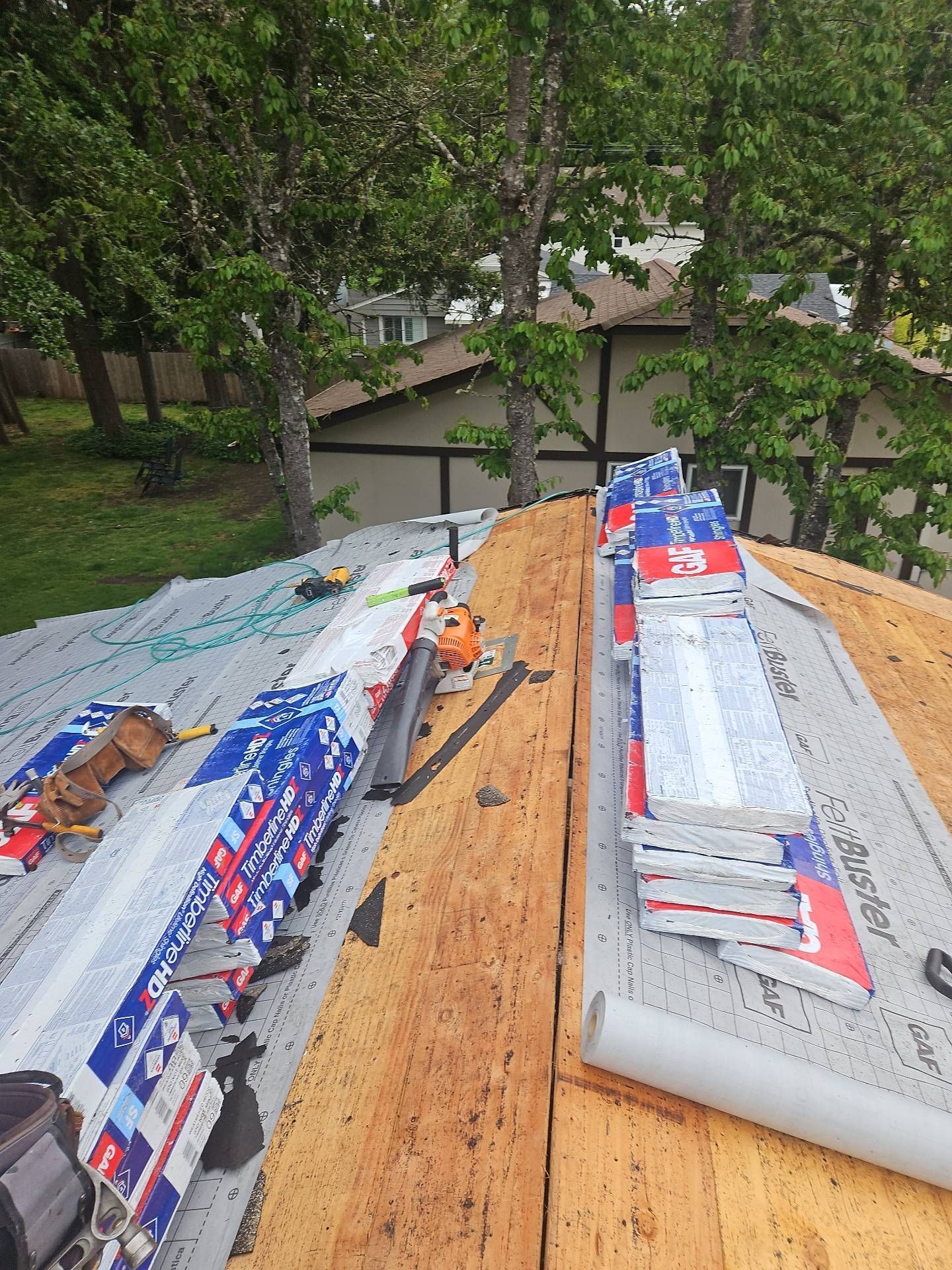 Roofing materials on a partially finished roof with visible plywood and underlayment by Team Roofing NW in Lakewood, WA.