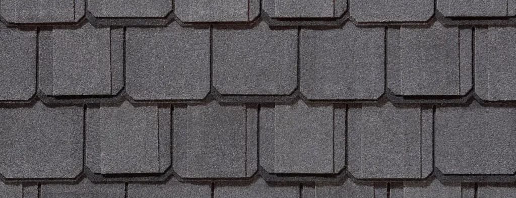 Close-up of gray asphalt roof shingles in a repeating pattern.