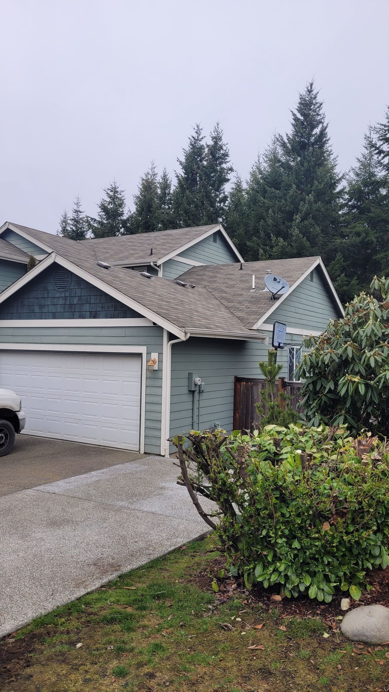 Damaged asphalt shingles before repair by Team Roofing NW in Kent, WA.