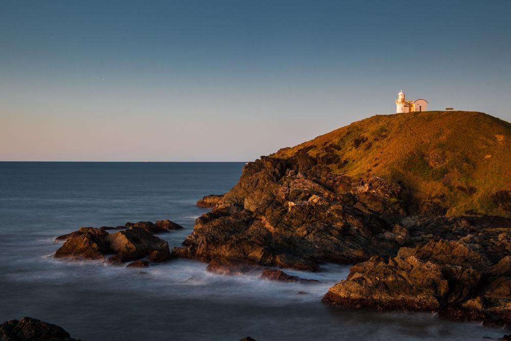 Lighthouse on a Hill Overlooking a Rocky Coastline at Dusk — BCV Storage Centre in Port Macquarie, NSW