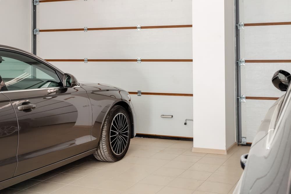 Two Cars Parked Inside a Garage With White Garage Doors — BCV Storage Centre in Wauchope, NSW