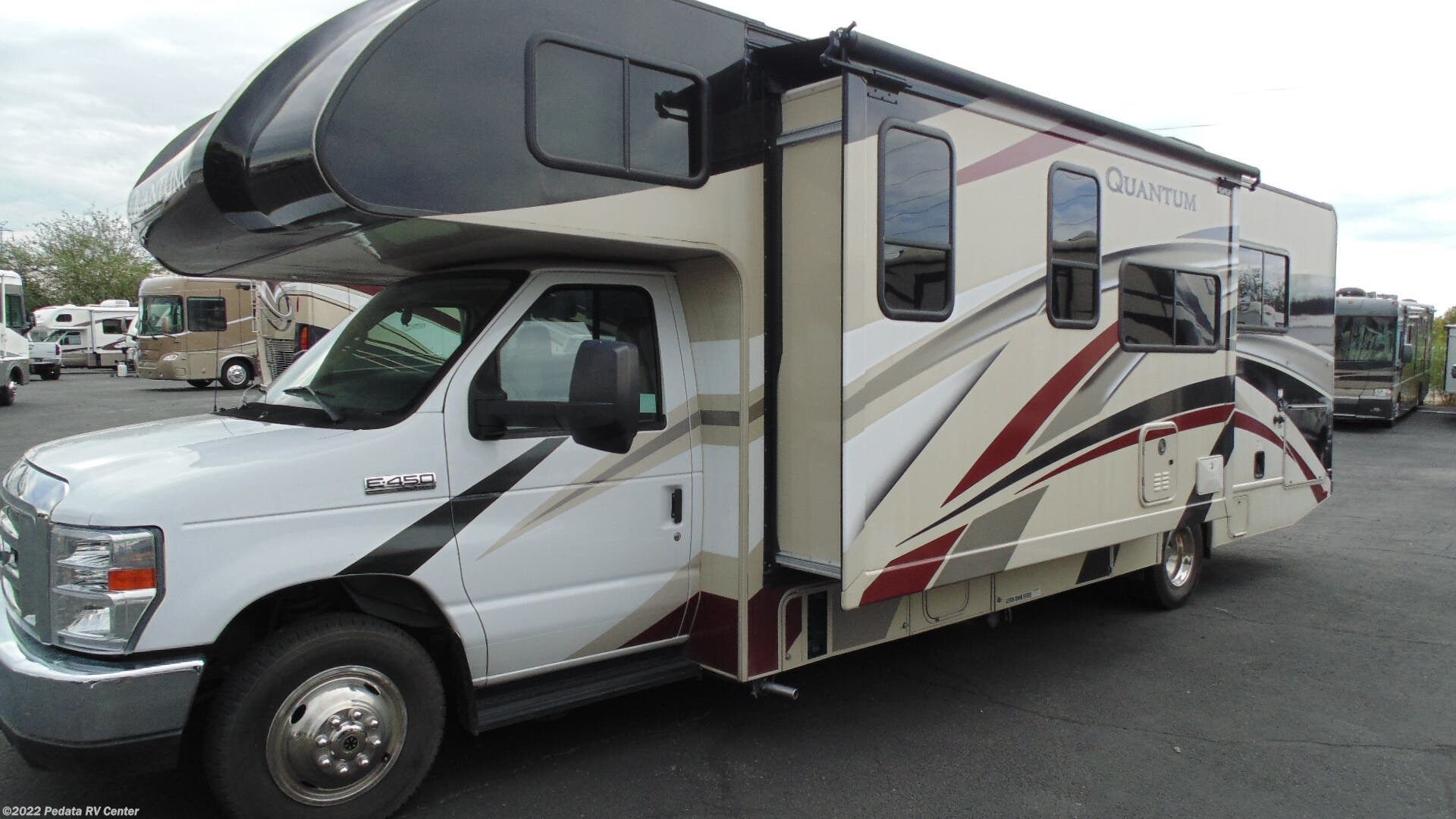 A white rv is parked in a parking lot.