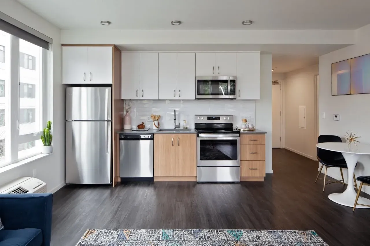 A modern kitchen with wooden cabinets and stainless steel appliances.
