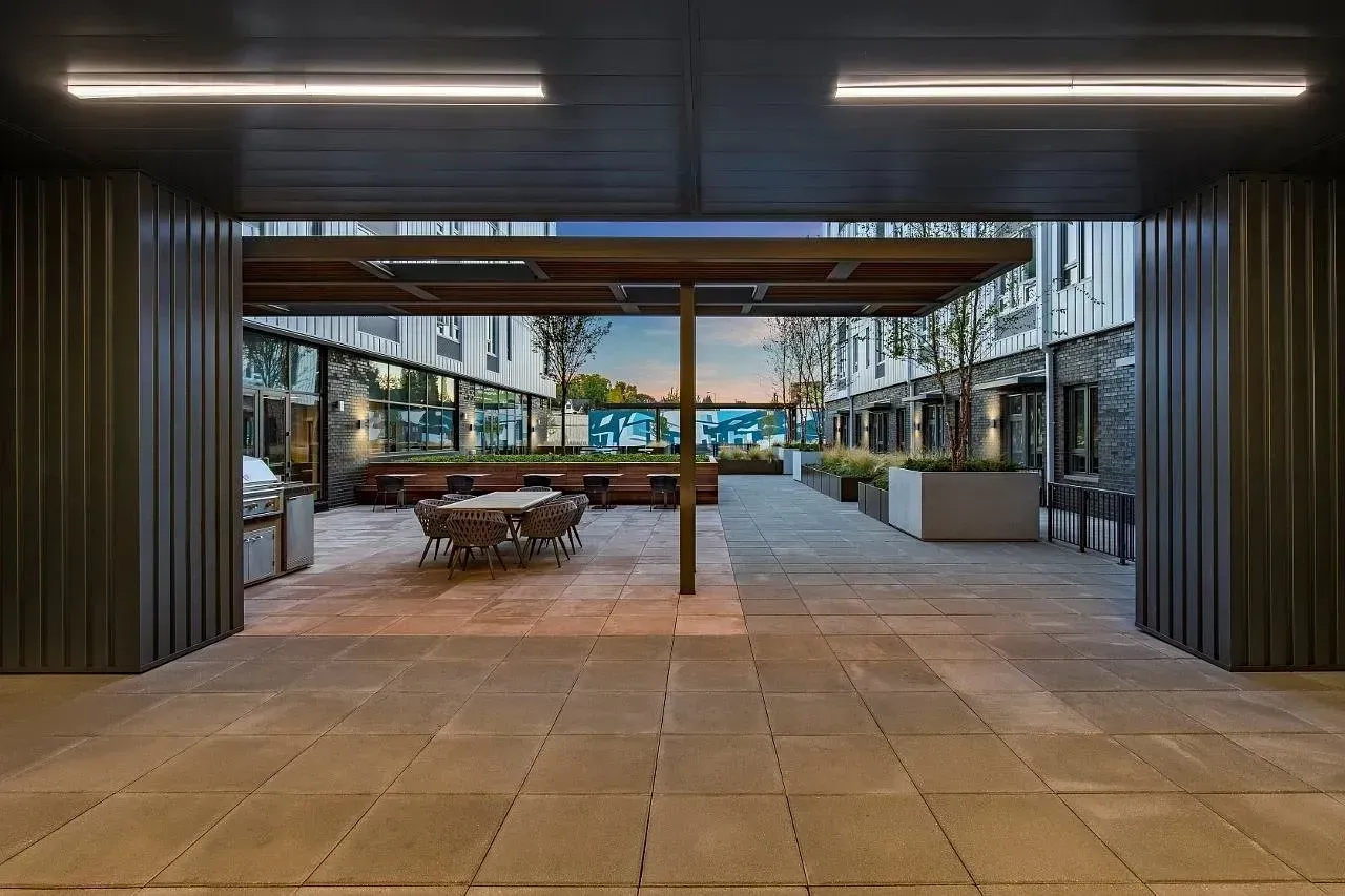 A modern outdoor seating area with a view of the city.
