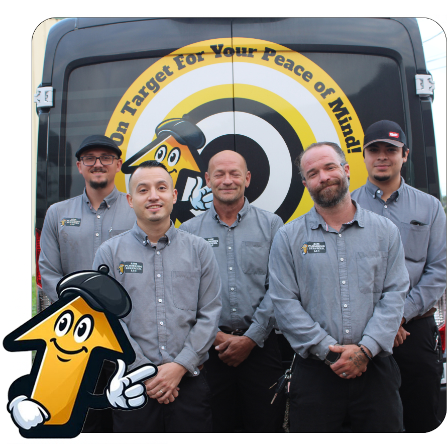 Team posing in front of a service van. They wear blue shirts with name badges. The van has a rainbow design.